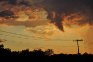 Power lines during sunset with clouds